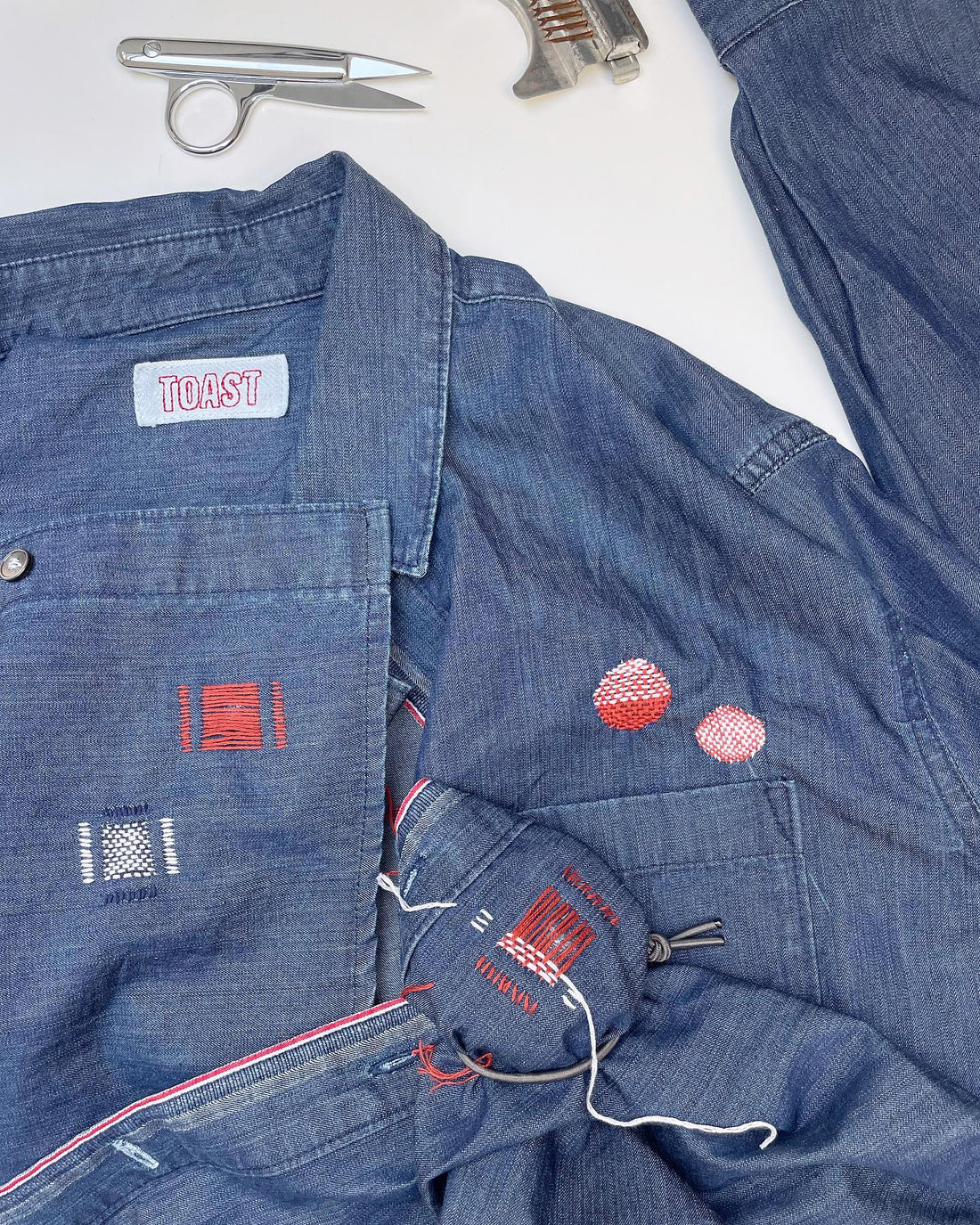 visible mending darned patches on a toast shirt by slow stitch club