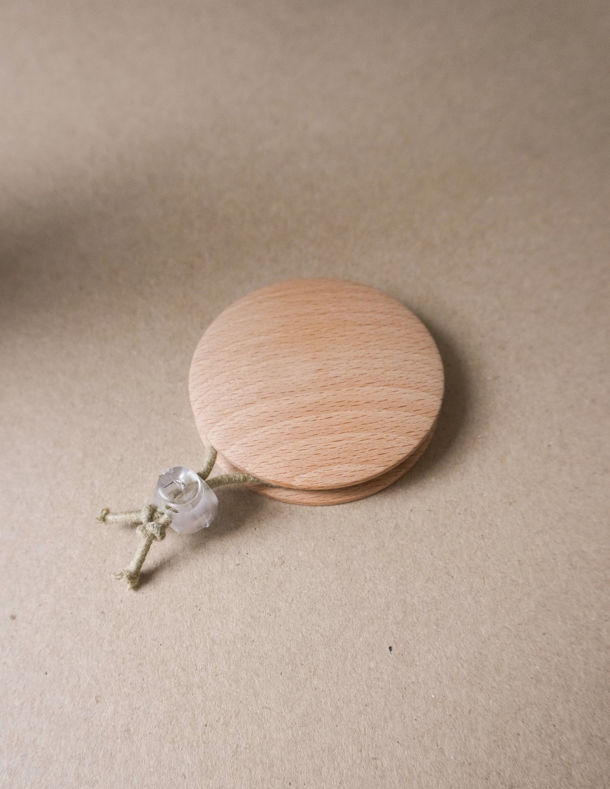 handmade wooden darning disc with elastic tie for visible mending and darning