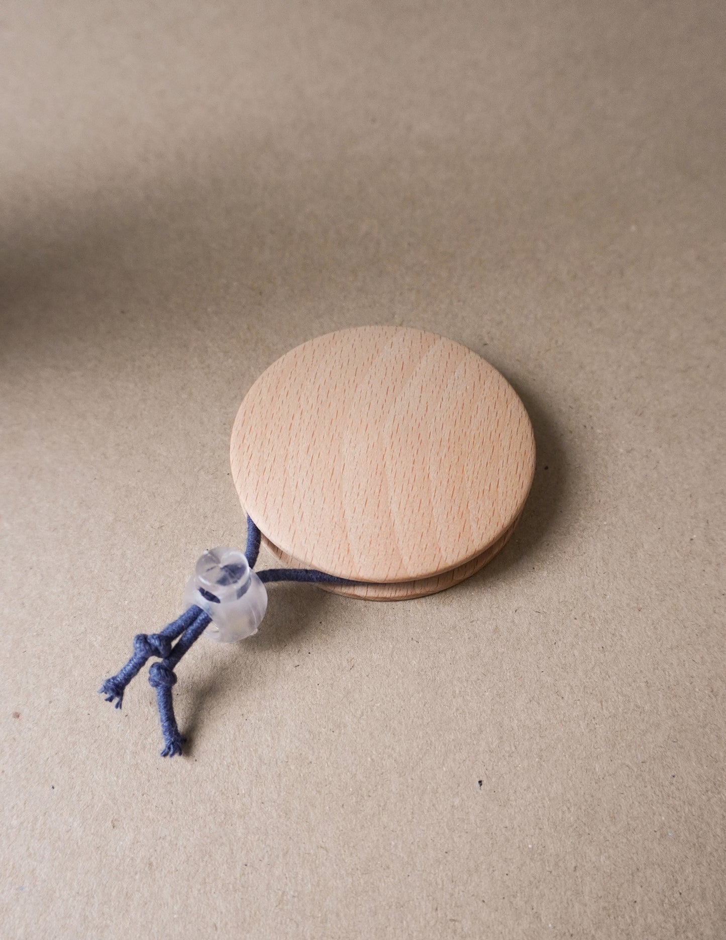 handmade wooden darning disc with elastic tie for visible mending and darning