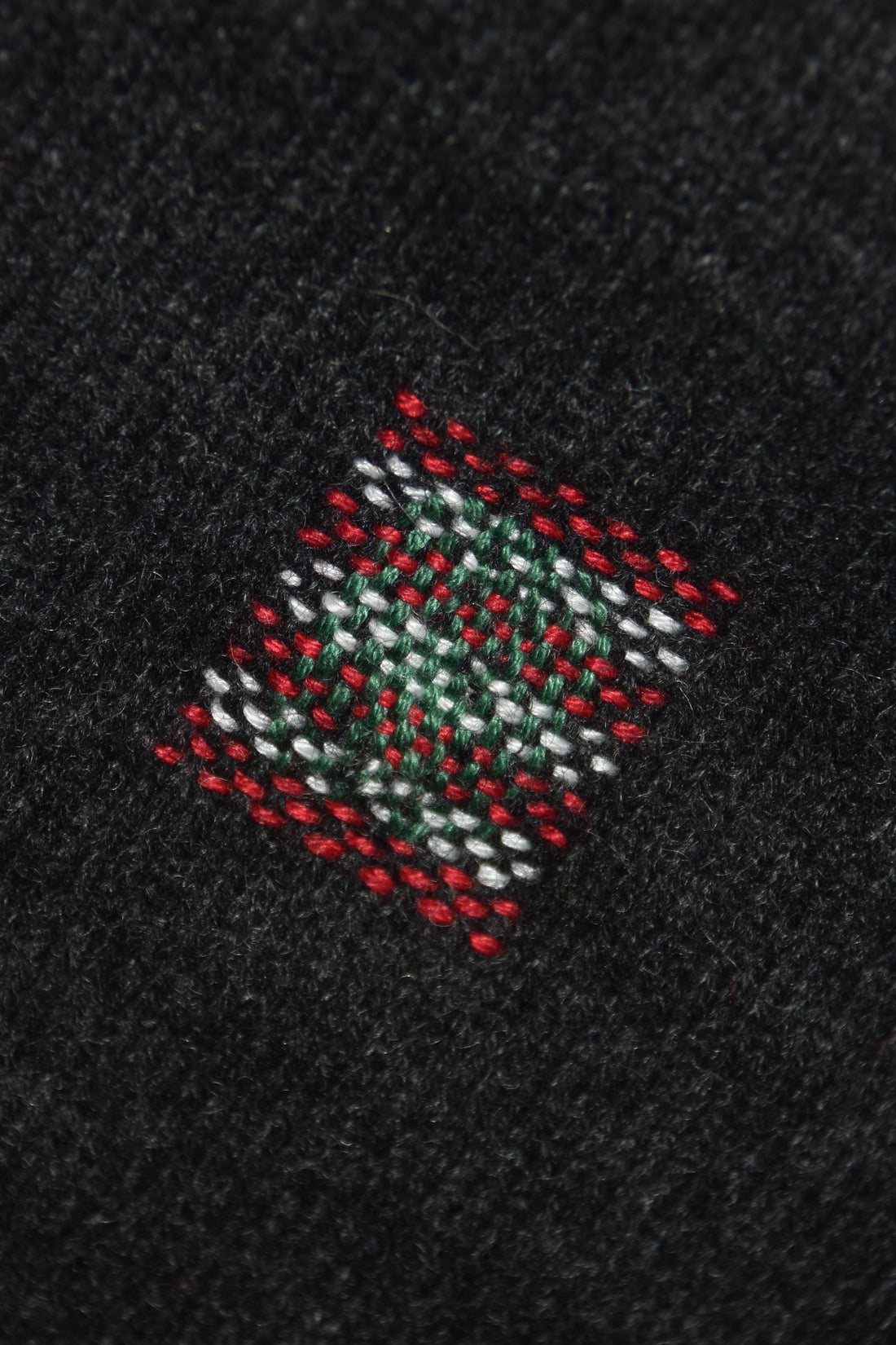 visibly mending a jumper to raise money for palestine