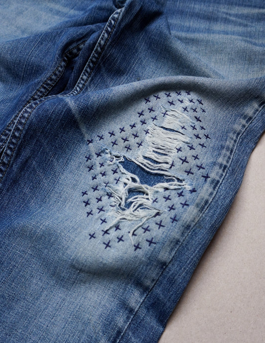 sashiko crosses to repair denim jeans visible mending