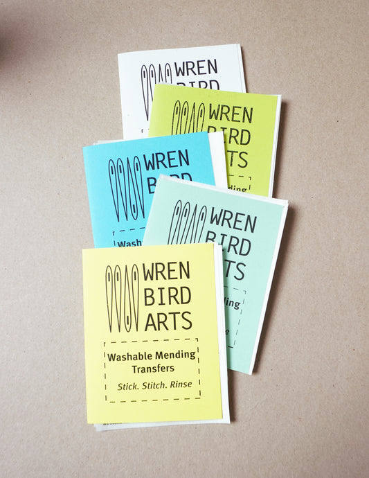 Set of Wren Bird Arts washable mending transfers on a beige background